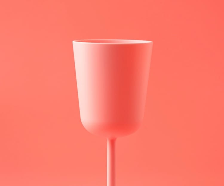 A glass in a soft red background